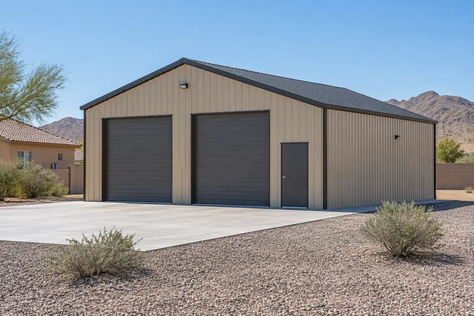 Tan metal workshop with two overhead doors and a concrete apron concept